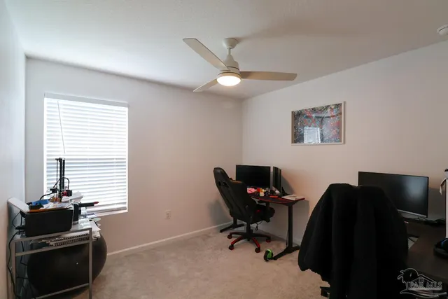 a view of a workspace with furniture and a window