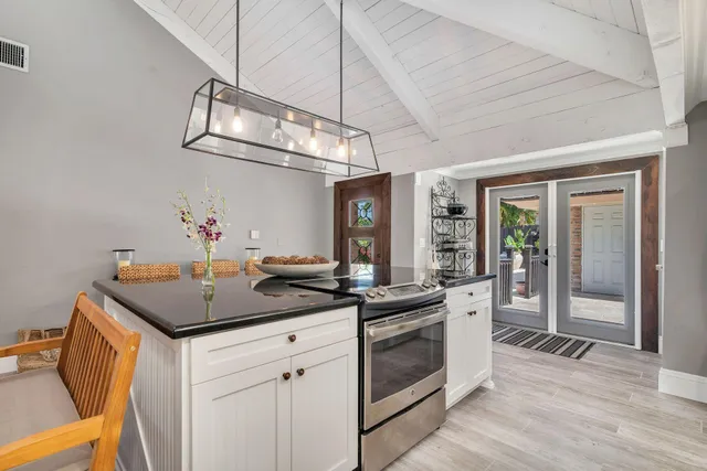 a kitchen with a sink stove and cabinets