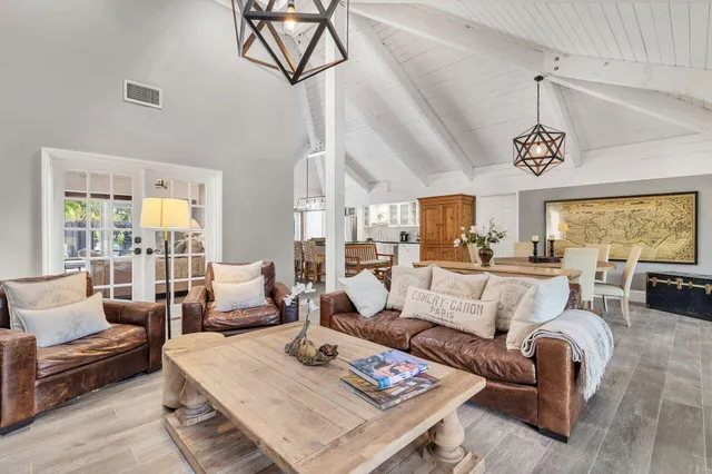 a living room with furniture a rug and a chandelier