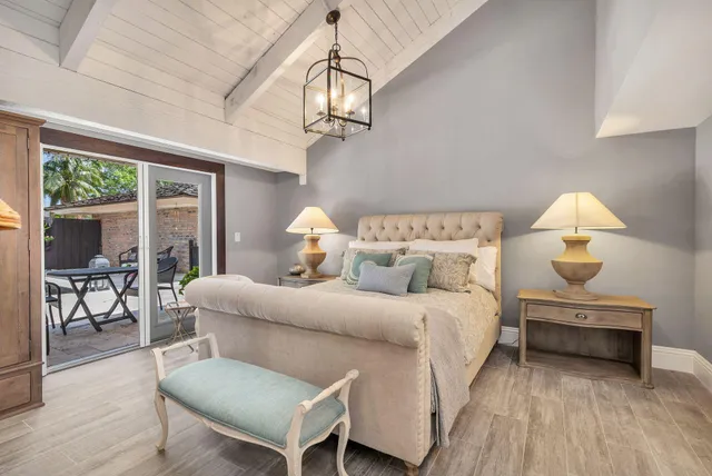 a bed room with a bed and a chandelier