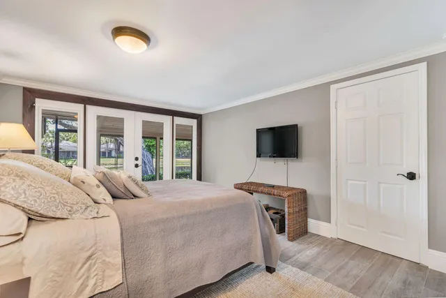 a bedroom with a bed and a flat screen tv