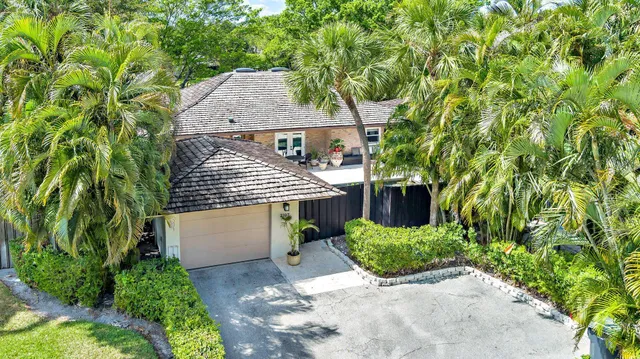an aerial view of a house with yard and greenery space