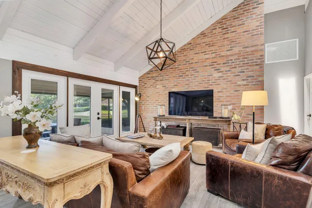 a living room with furniture a fireplace and a table