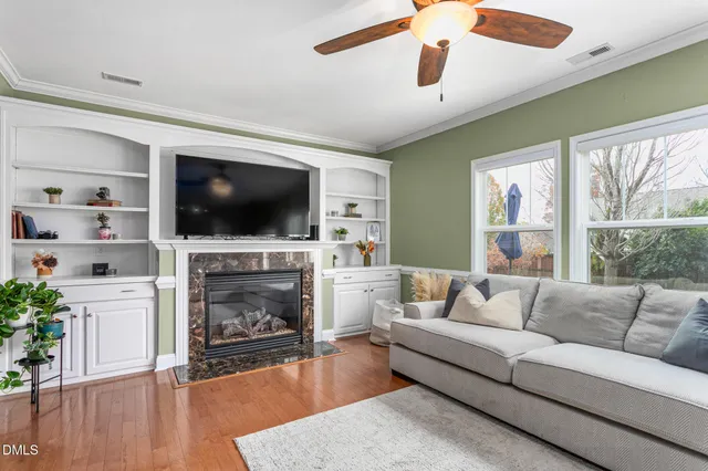 a living room with furniture a fireplace and a flat screen tv