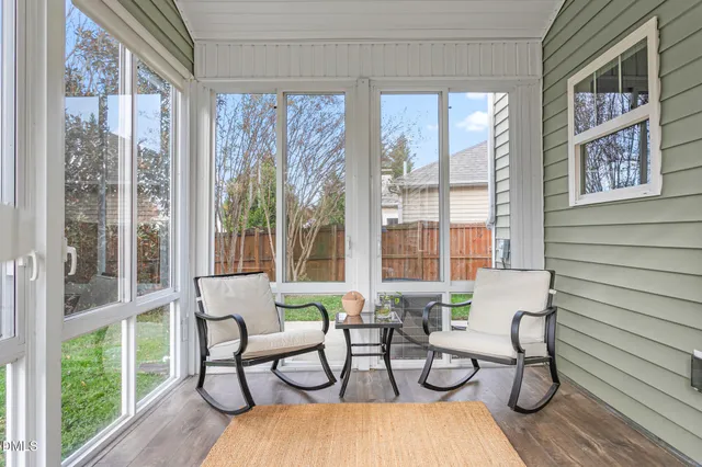 a livingroom with furniture wooden floor and windows
