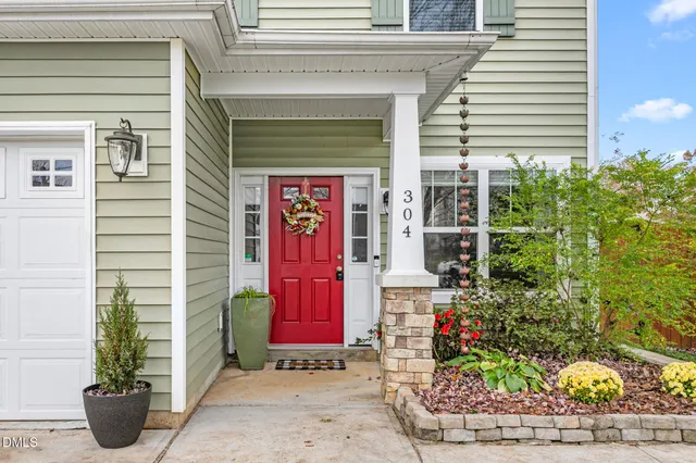 a front view of a house with plants