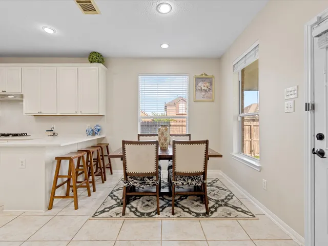 a view of a dining room with furniture and window