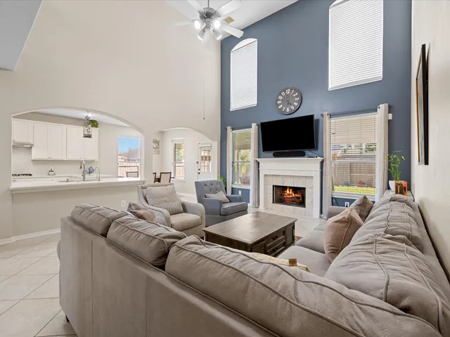 a living room with furniture a fireplace and a flat screen tv