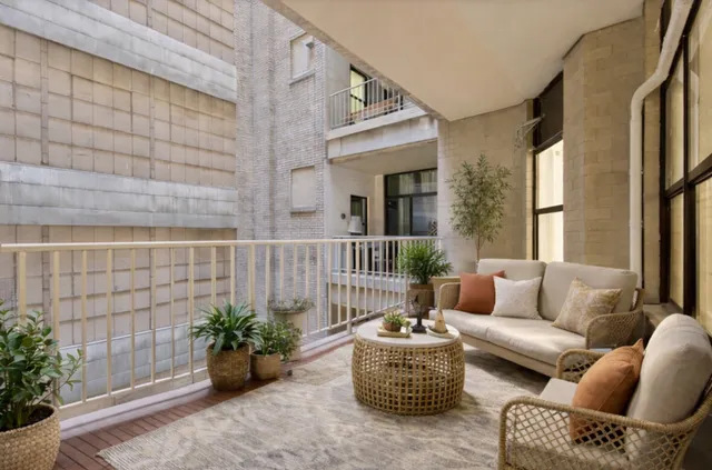 a balcony with furniture and flowers