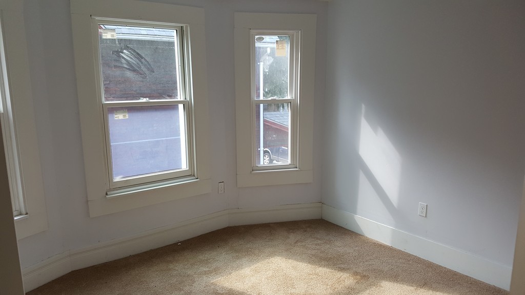 99 Alden Street Springfield, MA 01109 - Photo 16 of 21 an empty room with windows and closet