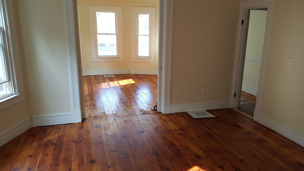 99 Alden Street Springfield, MA 01109 - Photo 7 of 21 an empty room with wooden floor and a window