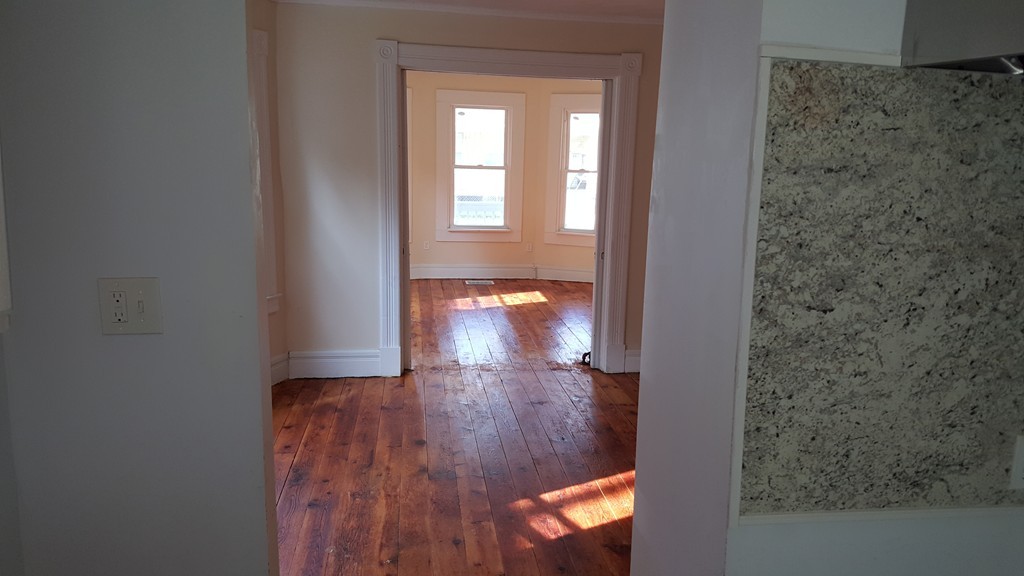 99 Alden Street Springfield, MA 01109 - Photo 8 of 21 wooden floor in an empty room with a window