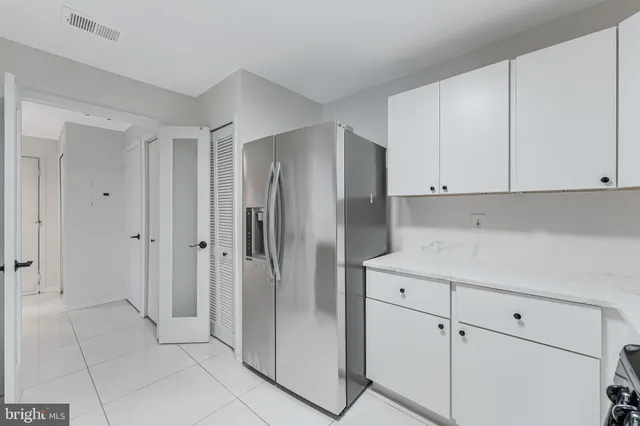 a kitchen with cabinets and a stainless steel appliances