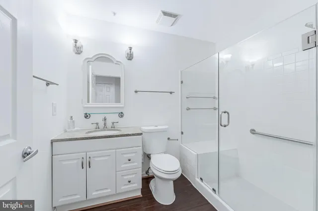 a bathroom with a toilet sink and shower
