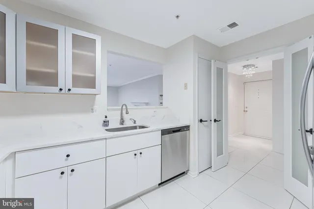 a kitchen with a sink and cabinets