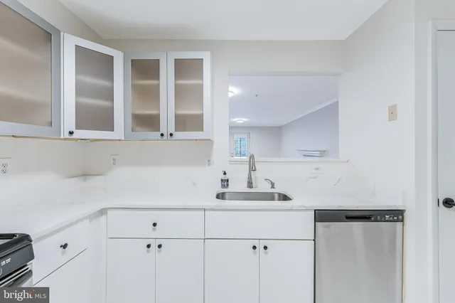 a kitchen with a sink and cabinets