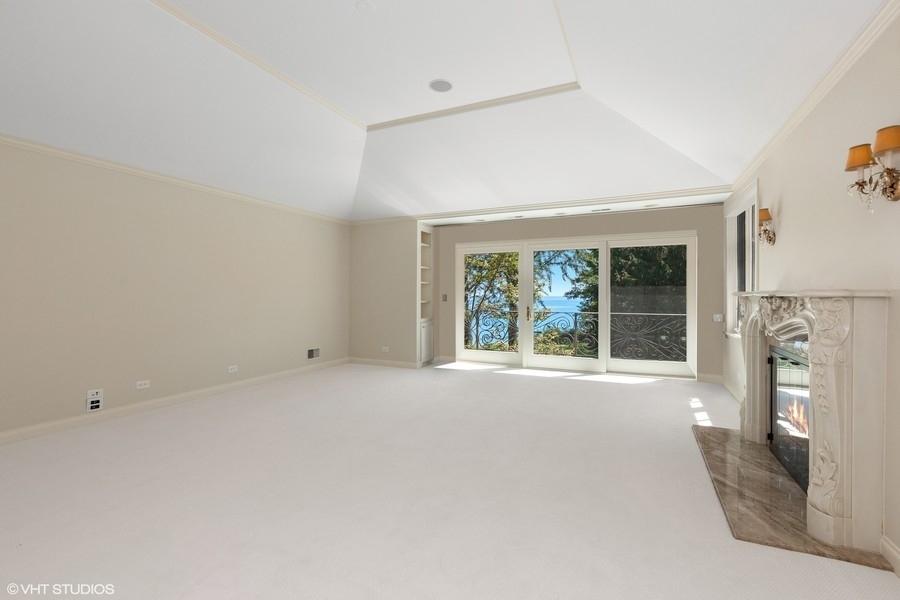 55 Stone Gate Road Lake Forest, IL 60045 - Photo 26 of 62 an empty room with a fireplace and windows