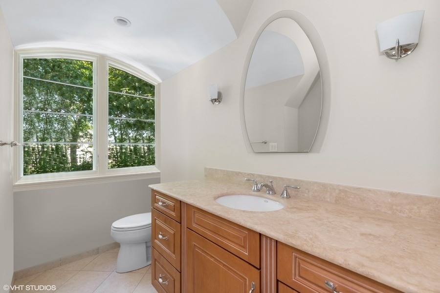 55 Stone Gate Road Lake Forest, IL 60045 - Photo 40 of 62 a bathroom with a sink a toilet and a mirror