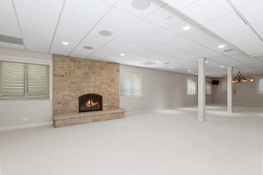 55 Stone Gate Road Lake Forest, IL 60045 - Photo 43 of 62 an empty room with a fireplace and window