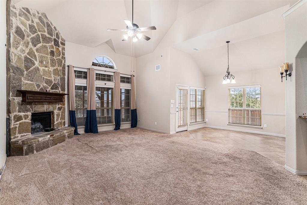 6132 Falls Lake Road Fort Worth, TX 76179 - Photo 11 of 37 a view of an empty room with a fireplace and a window
