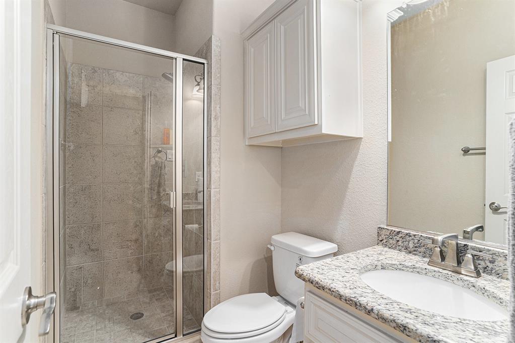 6132 Falls Lake Road Fort Worth, TX 76179 - Photo 15 of 37 a bathroom with a granite countertop sink toilet and shower