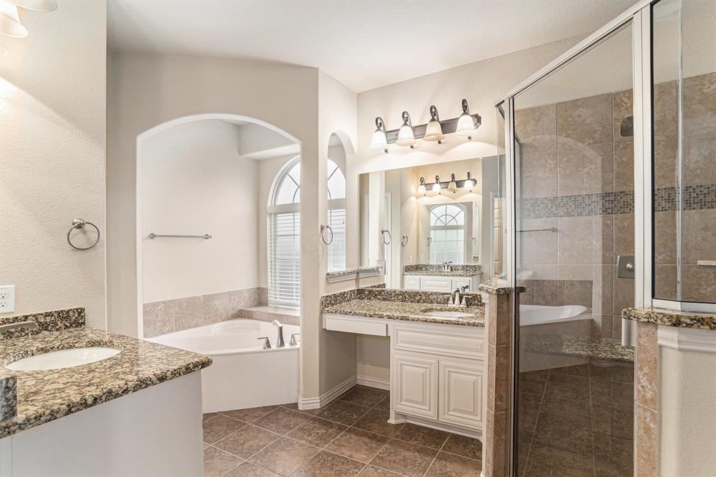 6132 Falls Lake Road Fort Worth, TX 76179 - Photo 19 of 37 a spacious bathroom with a granite countertop sink mirror and a bathtub