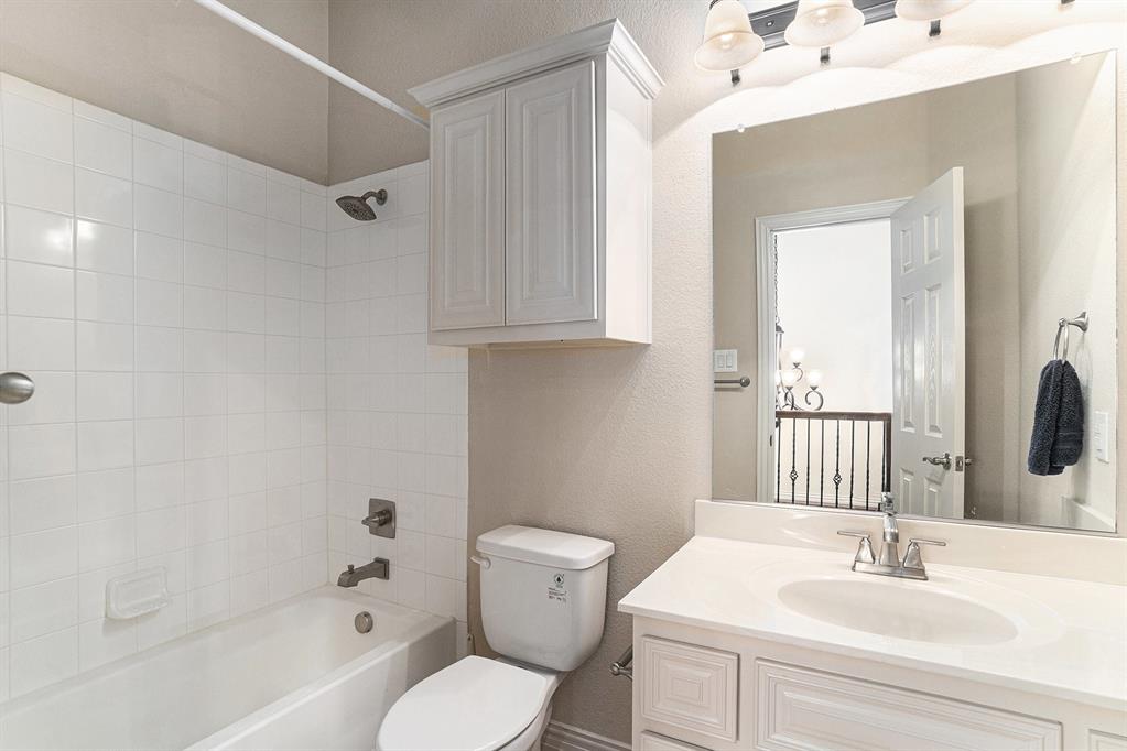 6132 Falls Lake Road Fort Worth, TX 76179 - Photo 28 of 37 a bathroom with a sink mirror vanity and toilet