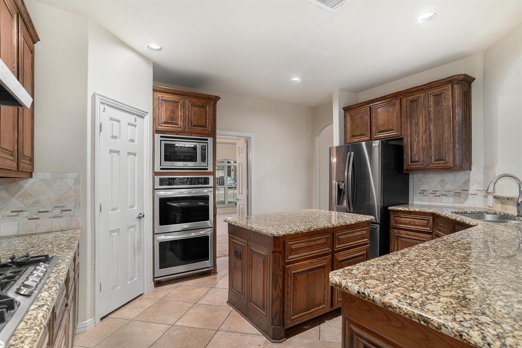 6132 Falls Lake Road Fort Worth, TX 76179 - Photo 8 of 37 a kitchen with stainless steel appliances and cabinets