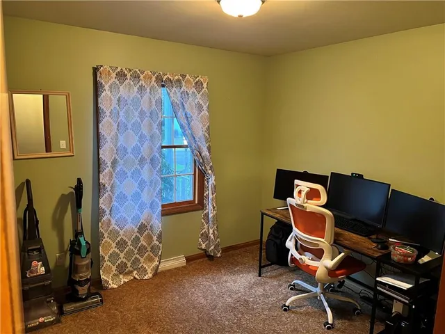 a view of a room that has a bed and mirror in it