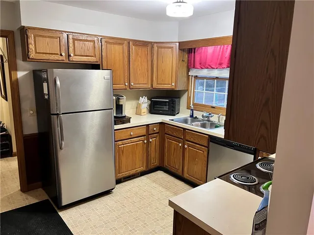 a kitchen with stainless steel appliances a refrigerator sink and cabinets