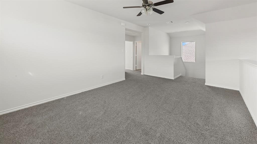 412 Carthage Street Caddo Mills, TX 75135 - Photo 22 of 32 Expansive carpeted room featuring white walls and a ceiling fan