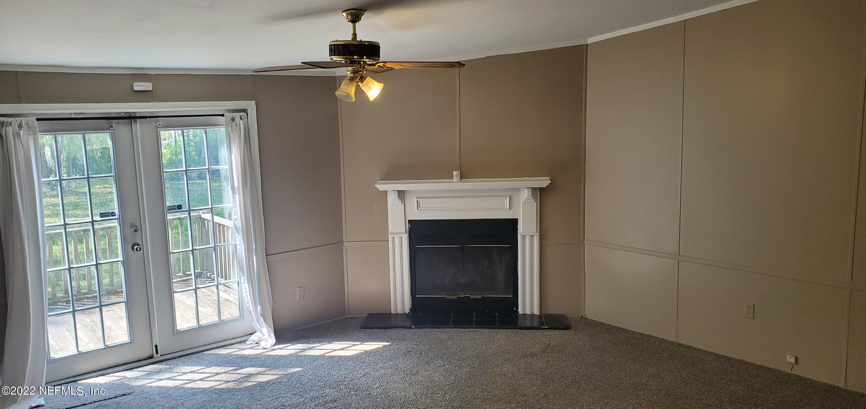 13464 Yellow Bluff Road Jacksonville, FL 32226 - Photo 4 of 20 a view of an empty room with a fireplace and a window