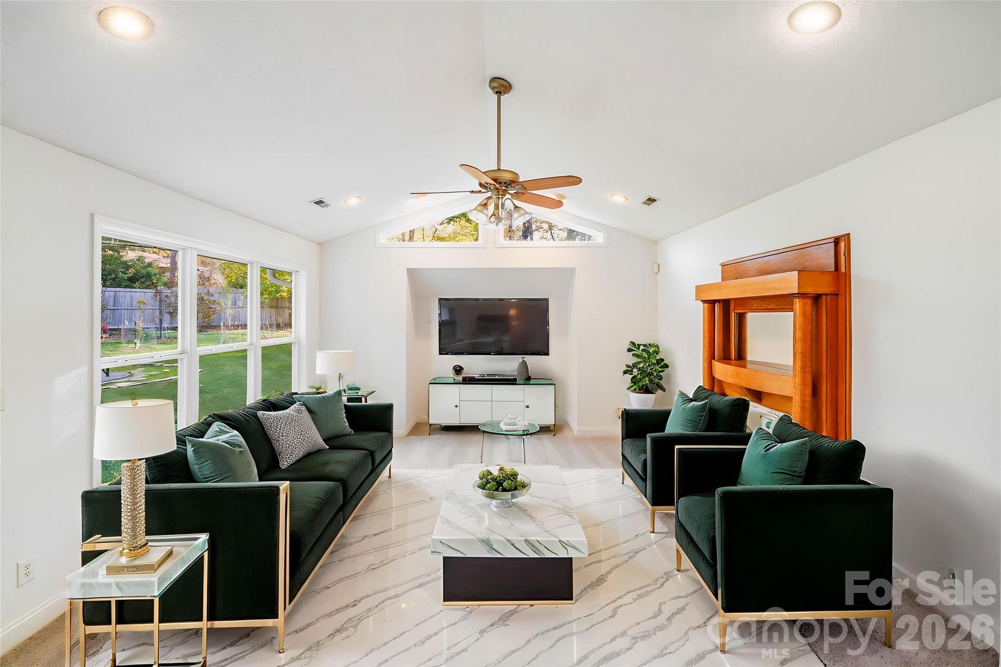 5329 Kuykendall Road Charlotte, NC 28270 - Photo 12 of 18 a living room with furniture a flat screen tv and a large window