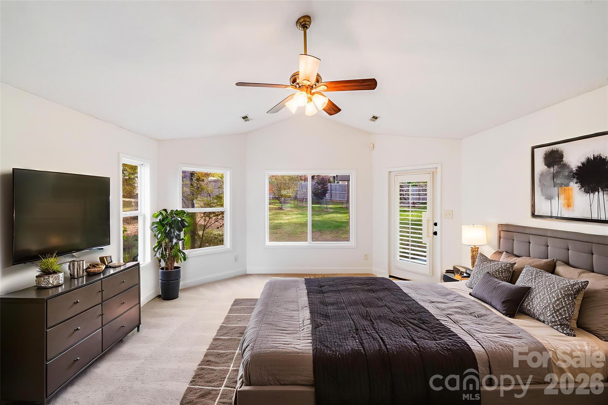 5329 Kuykendall Road Charlotte, NC 28270 - Photo 17 of 18 a bedroom with a large bed and a flat screen tv