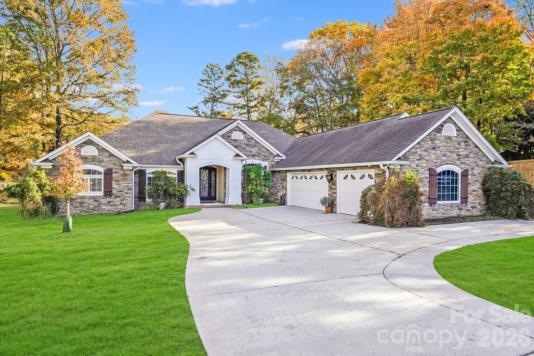 5329 Kuykendall Road Charlotte, NC 28270 - Photo 2 of 18 a front view of a house with a yard and garage