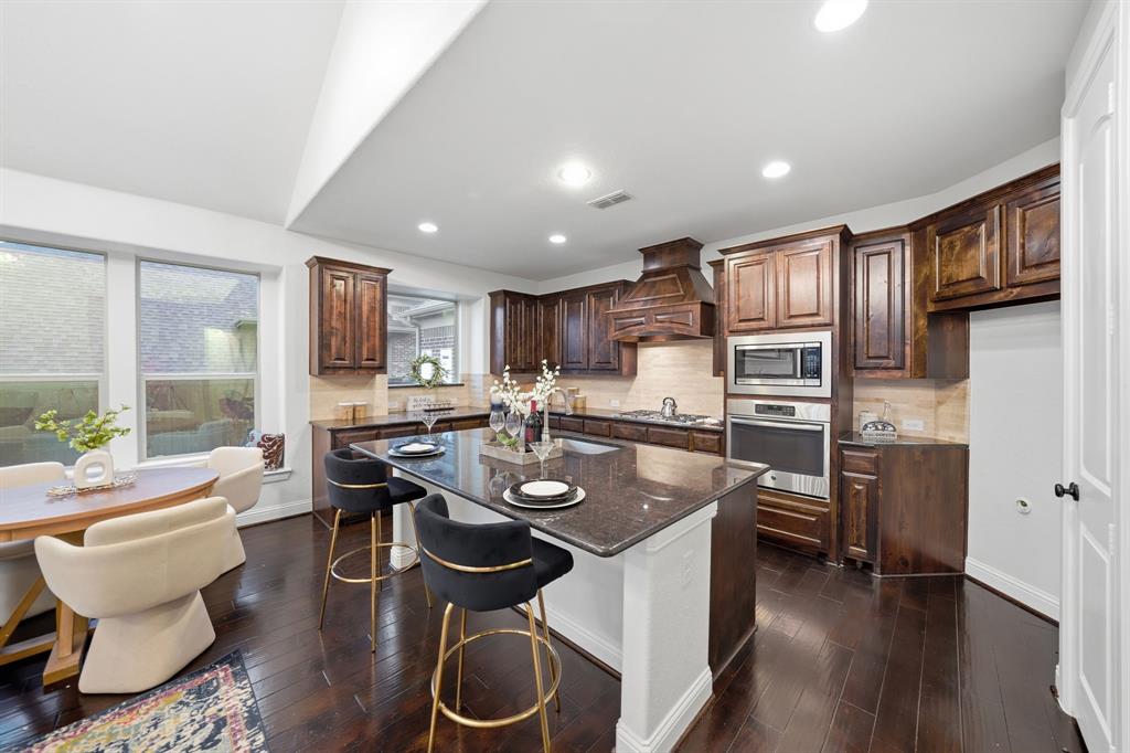 624 Sorrell Road McKinney, TX 75072 - Photo 9 of 28 a kitchen with stainless steel appliances granite countertop a sink stove and refrigerator