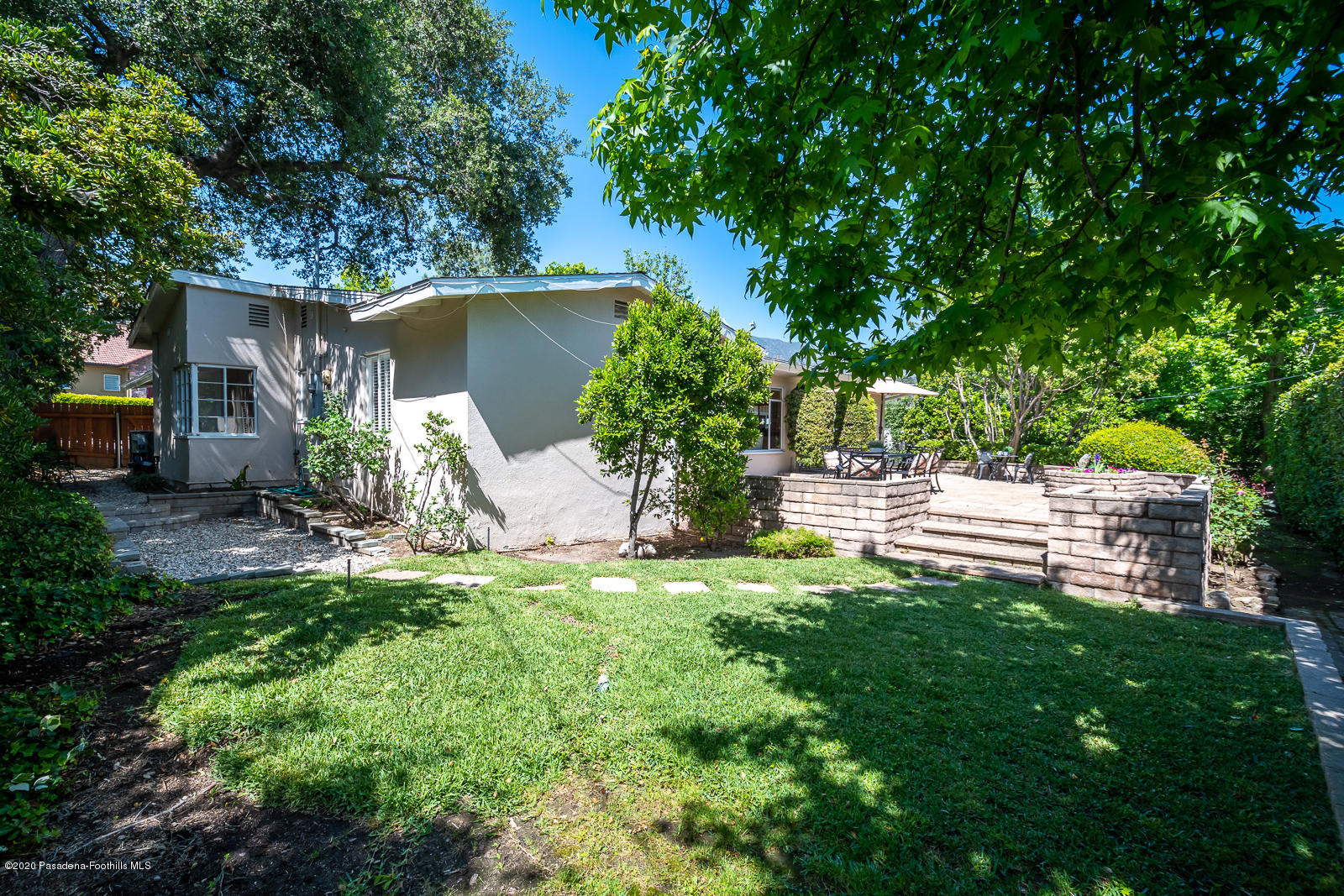 820 Chehalem Road La Canada Flintridge, CA 91011 - Photo 53 of 59 a view of a backyard with table and chairs and potted plants and large trees