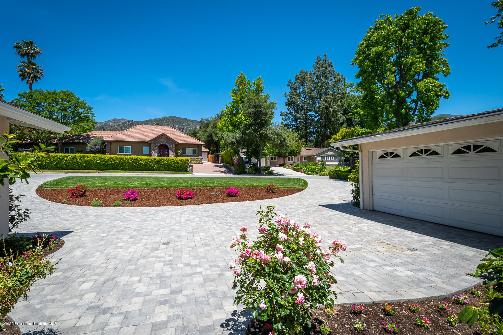 820 Chehalem Road La Canada Flintridge, CA 91011 - Photo 58 of 59 a view of a white house with a yard and potted plants