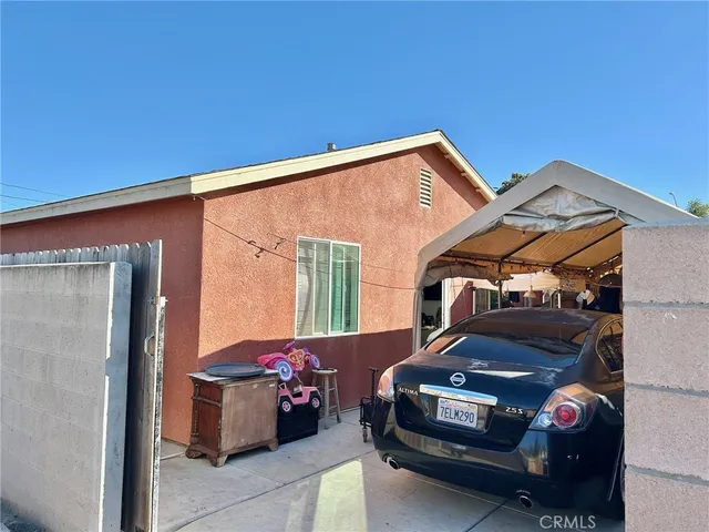 a view of a car park in front of a house