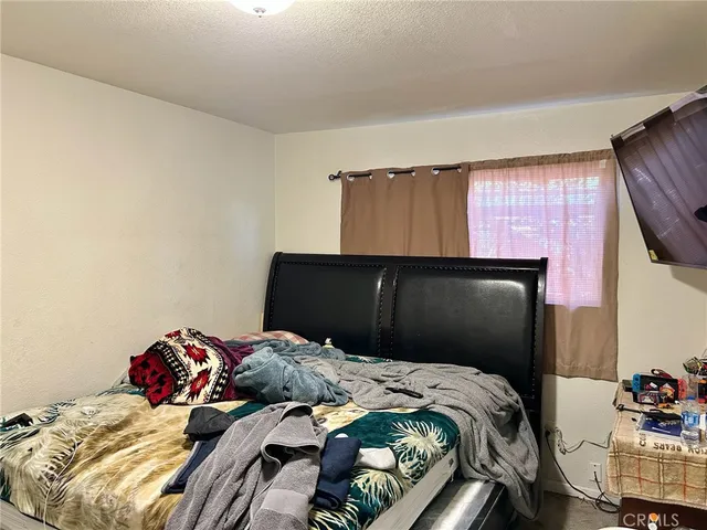a bedroom with a bed and dresser