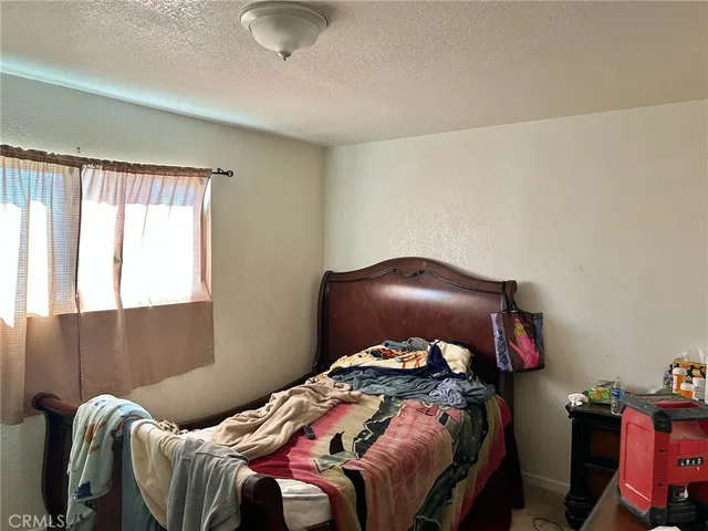 a bedroom with a bed and dresser