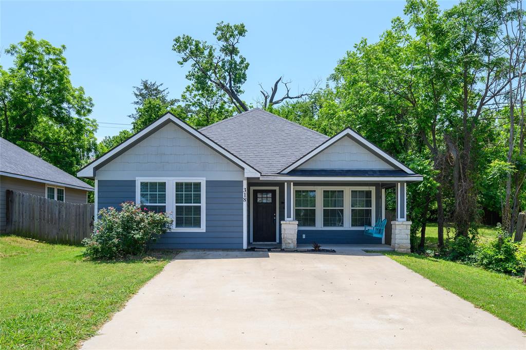 318 Munson Street Denison, TX 75021 - Photo 1 of 21 a view of a house with yard and tree s