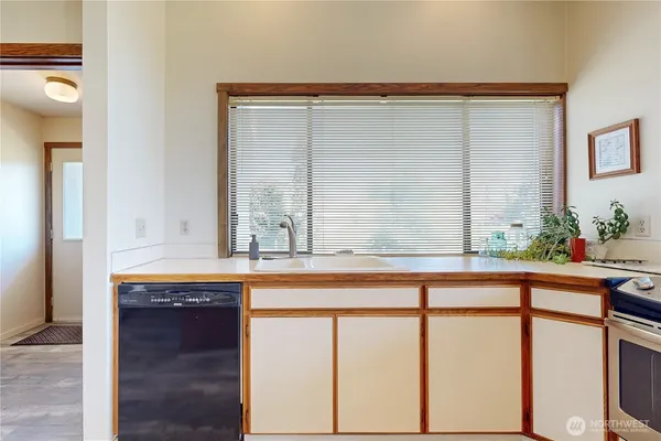 a bathroom with a granite countertop sink and a large mirror