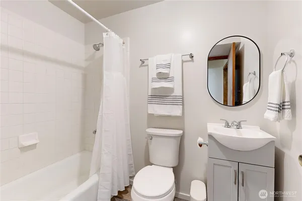 a bathroom with a sink toilet and a mirror