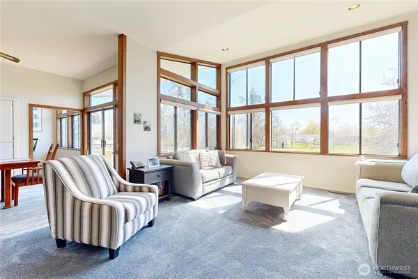 a living room with furniture and large windows