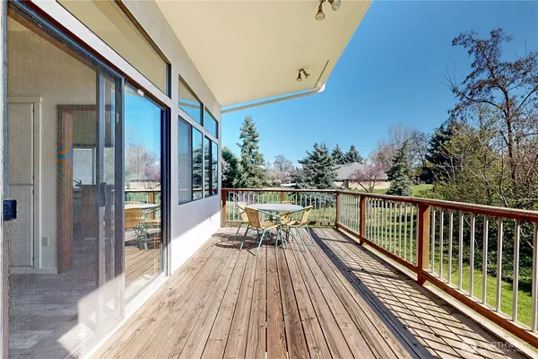 a view of balcony with chairs and wooden fence