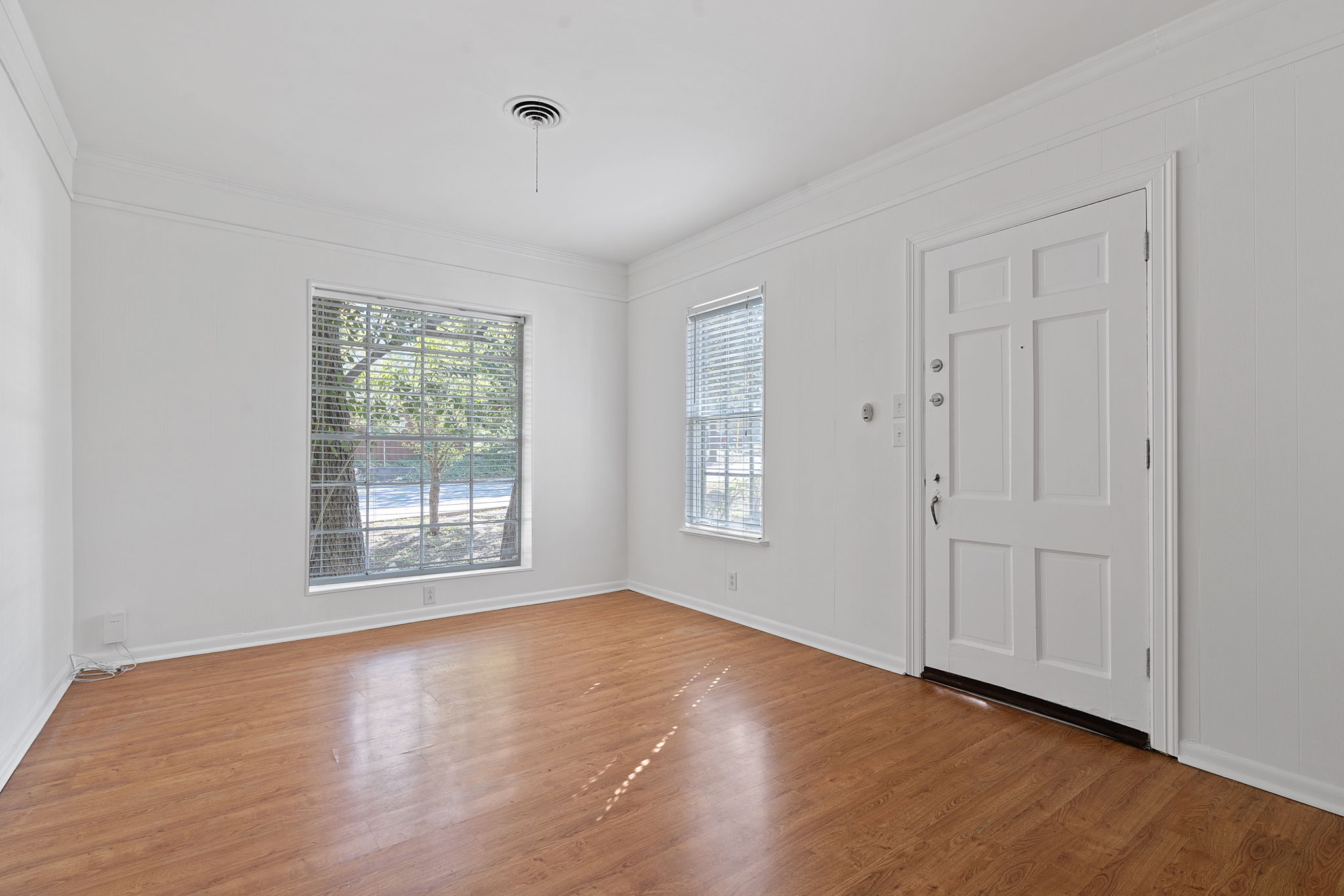 1700 Northwood Road Austin, TX 78703 - Photo 16 of 40 a view of an empty room with wooden floor and a window