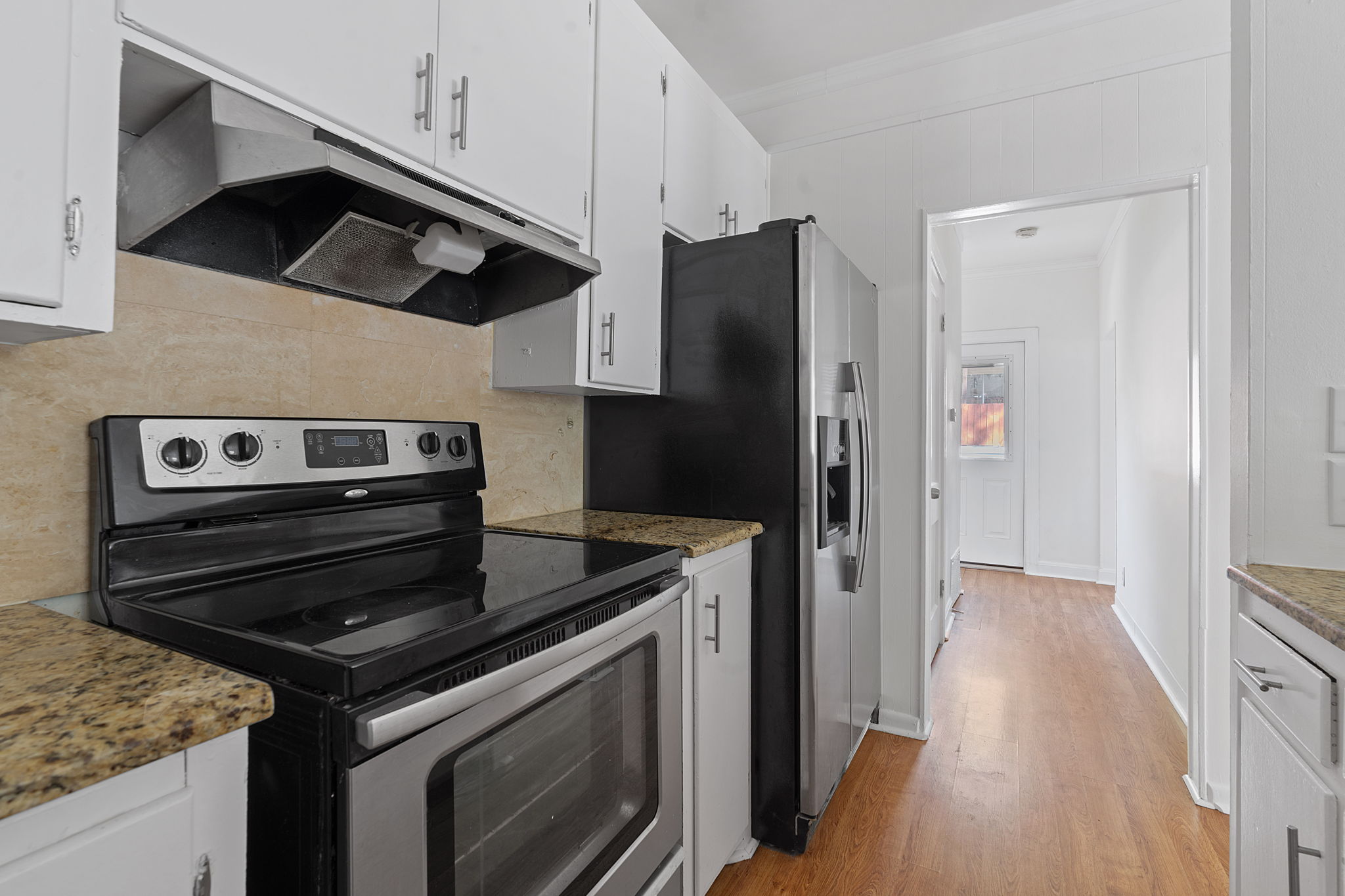 1700 Northwood Road Austin, TX 78703 - Photo 19 of 40 a kitchen with a stove microwave and refrigerator