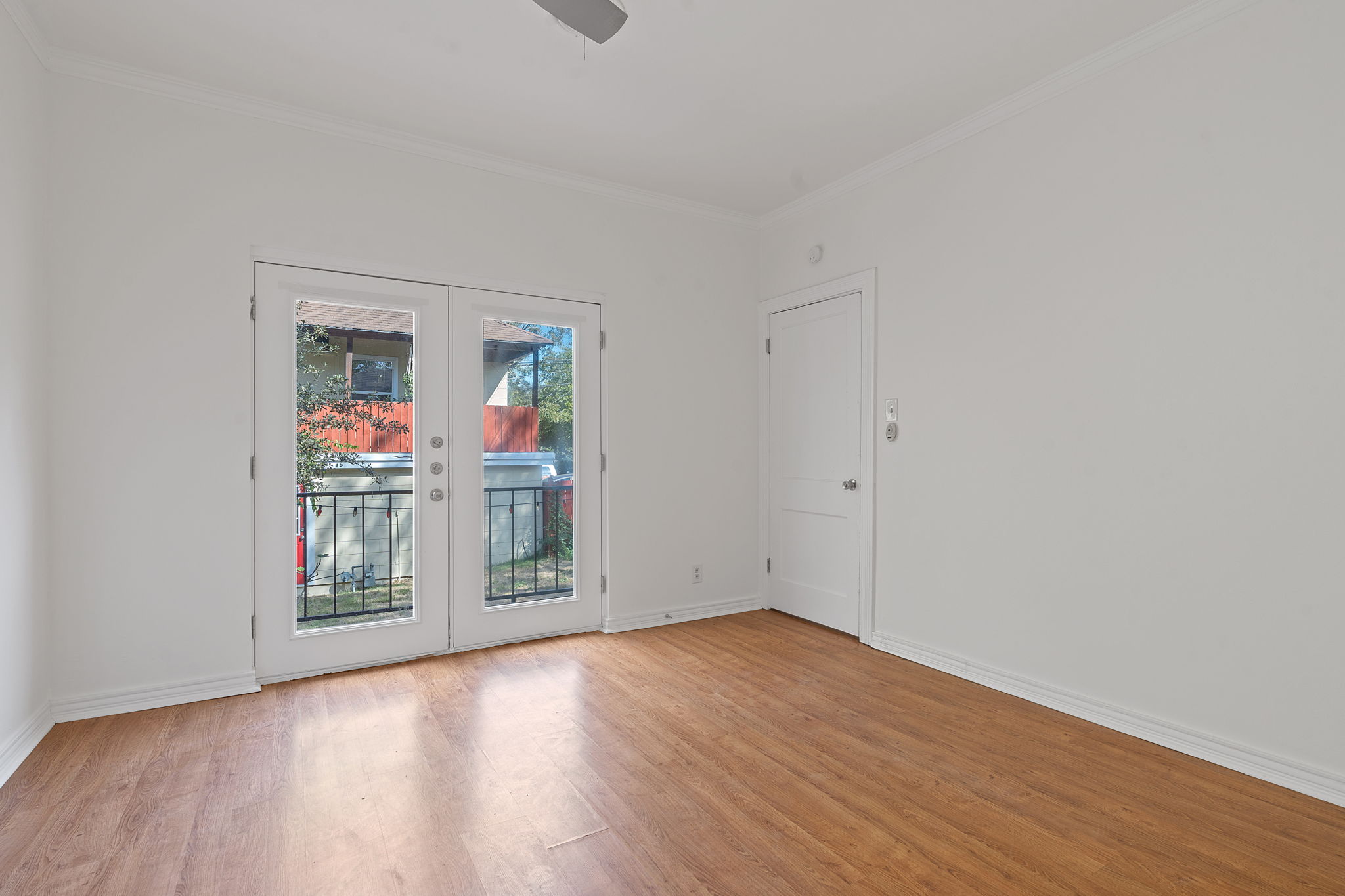 1700 Northwood Road Austin, TX 78703 - Photo 21 of 40 an empty room with wooden floor and windows