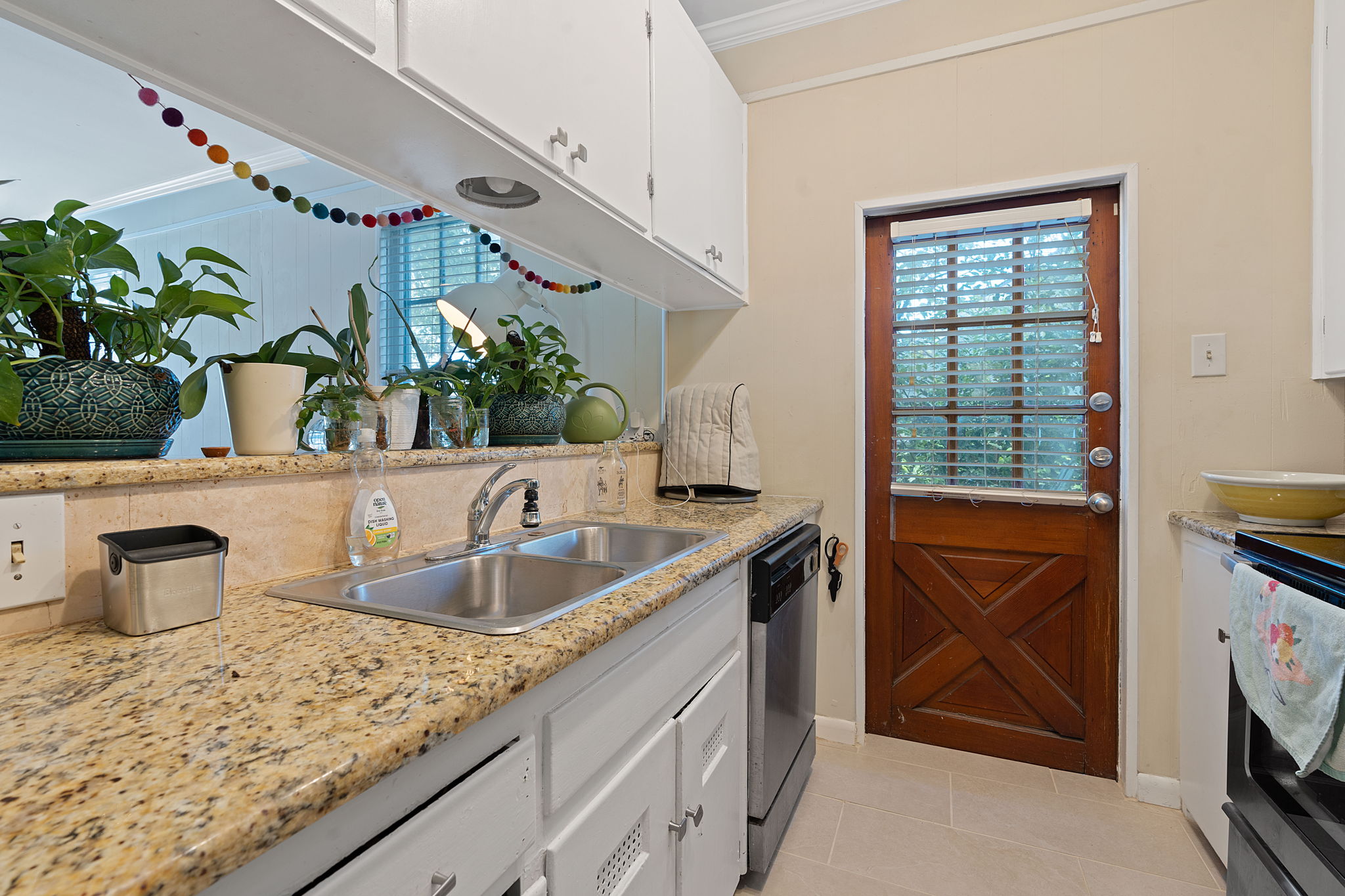 1700 Northwood Road Austin, TX 78703 - Photo 8 of 40 a kitchen with sink refrigerator and microwave